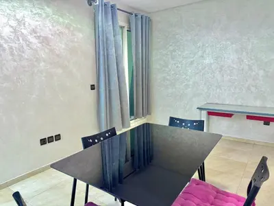a dining room with a table and chairs at Spacious family accommodation in Rabat