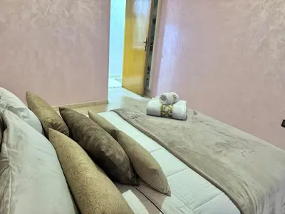 a bed with a teddy bear sitting on top of it at Spacious family accommodation in Rabat