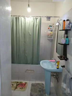 a bathroom with a shower curtain and a sink at Maison agdal 2 chambres salon in Rabat