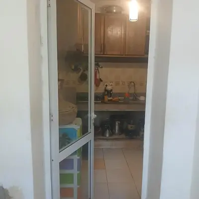 a kitchen with a door open to a pantry at Residence Les jardins de Belvedere in Casablanca