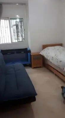 a small bedroom with a bed and a window at Sidi rehal in Sidi Rahal