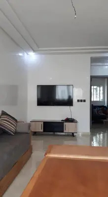 a living room with a couch and a flat screen tv at Sidi rehal in Sidi Rahal