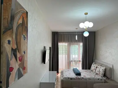 a living room with a bed and a painting on the wall at Nice studio in Rabat