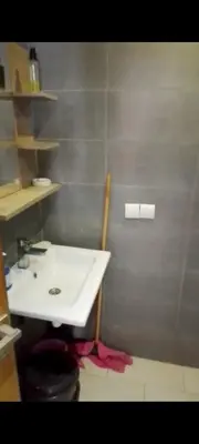 a bathroom with a white sink and a toilet at Mansbay in O Ben Slimane