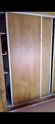 ajar door of a closet with a wooden door at Mansbay in O Ben Slimane