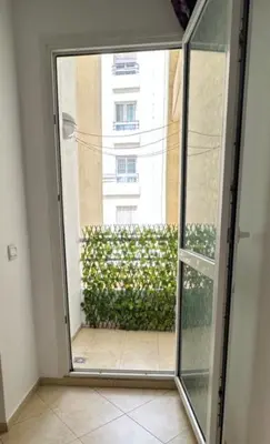 an open glass door with a view of a building at Appartement moderne à Bourgogne 2 chambre in Casablanca-Port