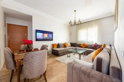 a living room with a couch and a table at Ocean Apartment in Rabat