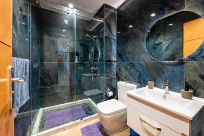 a bathroom with a shower and a toilet and a sink at Ocean Apartment in Rabat