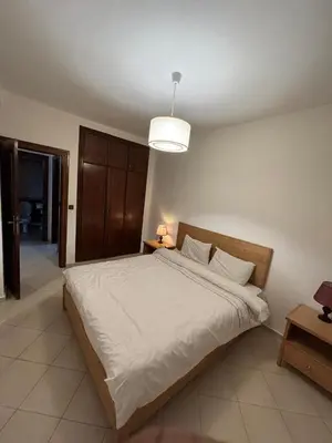a bedroom with a large white bed with a light at Chic Studio in Agdal Walk to Everything in Rabat
