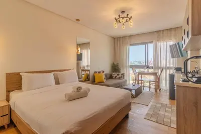 a bedroom with a large bed and a living room at Marina Lifestyle ! in Casablanca