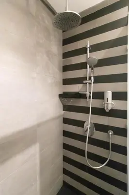 a shower in a bathroom with black and white stripes at Marina Lifestyle ! in Casablanca