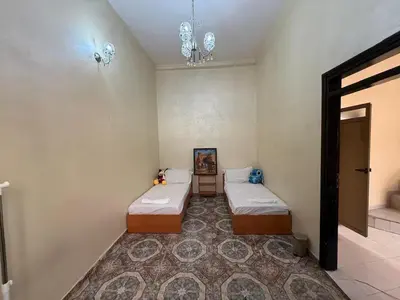 a room with two beds in a room with a rug at Charmante Maison Traditionnelle au Cœur de la Médina, 5 min de Casa Port in Casablanca