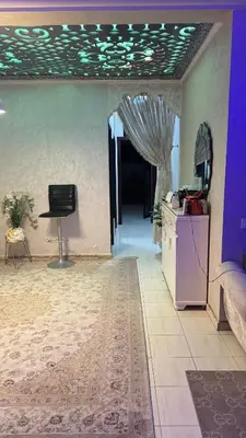 a living room with a table and a chair at Diar 4 in Casablanca