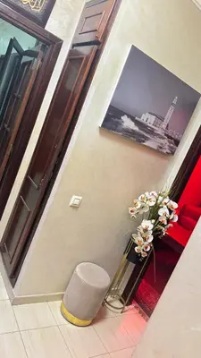 a stairway with a vase of flowers and a picture at Diar 4 in Casablanca