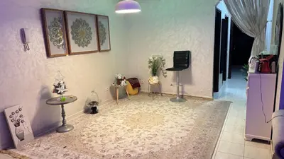 a living room with a table and a tv on the wall at Diar 4 in Casablanca