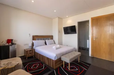 a hotel room with a bed and a tv at Studio prestige avec Terrasse sur la Marina in Casablanca