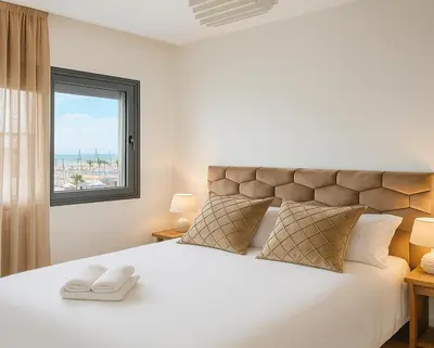a bedroom with a large white bed with a window at Cosy ensoleillé 2CH proche de Mosquee hassan II et corniche in Casablanca
