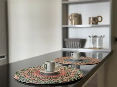 two plates with coffee cups on a counter at 2br near TGV station in Rabat