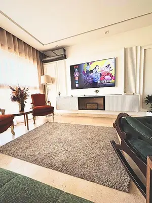 a living room with a flat screen tv on a wall at Appartement moderne avec équipements de luxe in Maarif