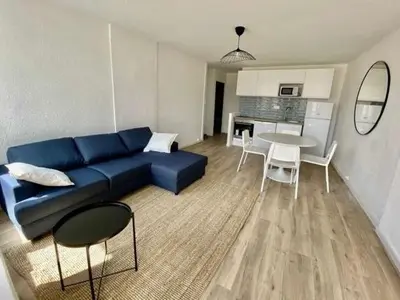 a living room with a blue couch and a table at Chic and Calm Flat in Heart of Casa in Casablanca