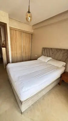 a bedroom with a large bed with white sheets at Maison vacances Mansoria in Casablanca