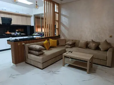 a living room with a couch and a coffee table at Jolie appartement Bouznika in Bouznika