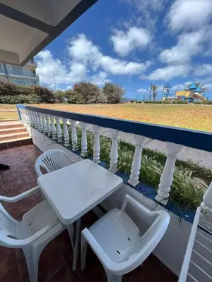 a white table and two chairs on a balcony at Apartment with swimming pool in O Ben Slimane