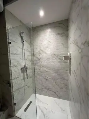 a bathroom with a shower with a glass door at Sunshine in Casablanca
