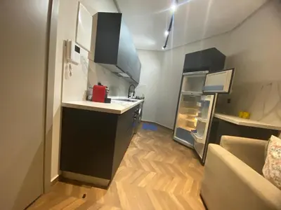 a small kitchen with a refrigerator and a counter top at The Quiet House in Casablanca