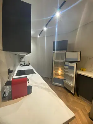 a kitchen with a sink and a refrigerator at The Quiet House in Casablanca
