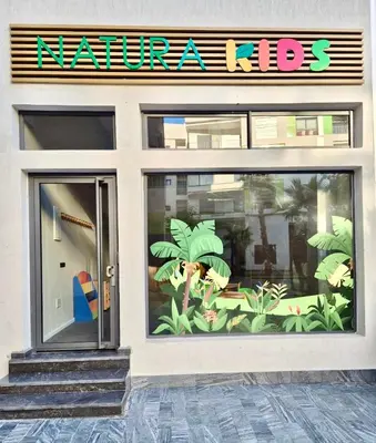 a store front with a window with plants on it at Natura Living Apartment in Mohammedia