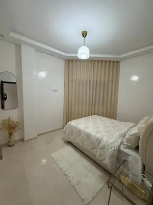 a bedroom with a bed and a television in it at Elegant apartment Racine Bd AlMassira in Casablanca
