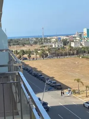 a row of cars parked in a parking lot at Appartement Kettani bouznika in Bouznika