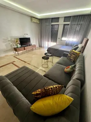 a living room with a couches and a couch at Large bright and centrally located studio in Casablanca