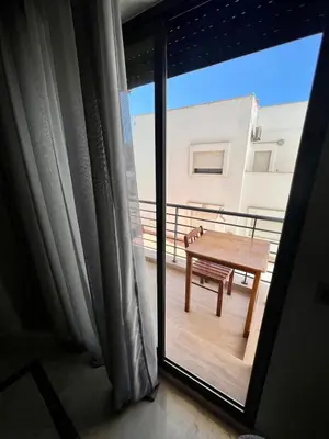 a room with a table on a balcony with a window at Large bright and centrally located studio in Casablanca