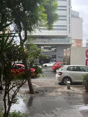 a parking lot with cars parked in front of a building at Large bright and centrally located studio in Casablanca