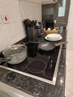 a stove top with pots and pans on a counter at Chez Maud Skhirat-Rabat in Skhirat