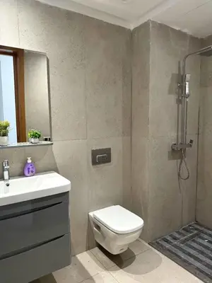 a bathroom with a toilet and a sink and a shower at Sidi Rahal Oceanic Appartement vue sur piscine in Sidi Rahal