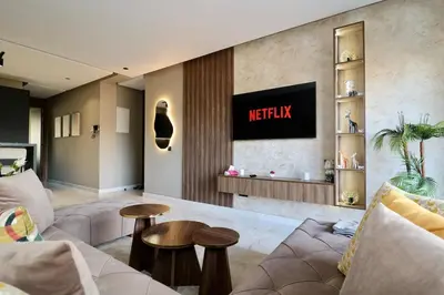 a living room with a couch and a tv on the wall at Luxurious and modern studio on Maarif-Franceville in Casablanca