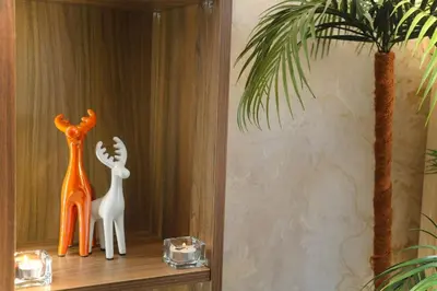 two plastic animals sitting on a shelf next to a palm tree at Luxurious and modern studio on Maarif-Franceville in Casablanca