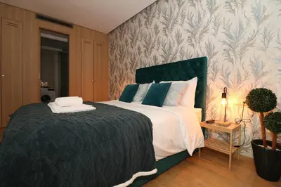 a bedroom with a large bed with a green headboard at Studio luxueux sur Val d'anfa in Casablanca