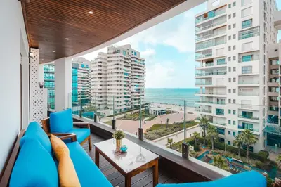 a balcony with blue furniture and a view of the ocean at TheBesty Ocean Apartment 2MBd- By Appart'Ayla in Casablanca