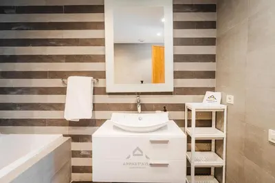 a bathroom with a sink and a mirror at TheBesty Ocean Apartment 2MBd- By Appart'Ayla in Casablanca