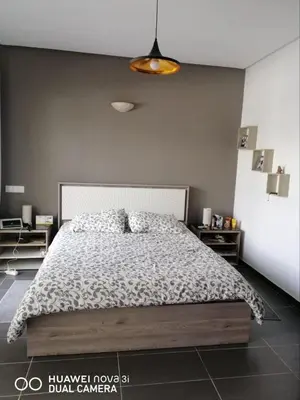 a bedroom with a large bed in a room at Appartement Résidence balnéaire Dar Al bahr in Sidi Rahal