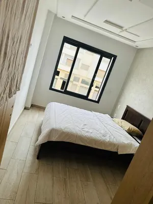 a bedroom with a large bed and a window at Appartement vu sur mer in Pont Blondin