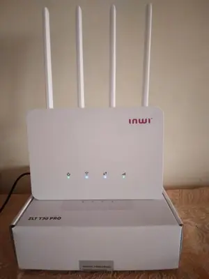 a white router sitting on top of a table at Bab fes Appartement 2 pièces à Aïn Sebaâ Casablanca in Aïn Sebaa