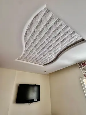 a room with a tv and a ceiling at Wifak beach rental in Temara