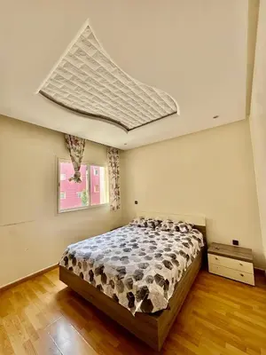 a bedroom with a large bed in a room at Wifak beach rental in Temara