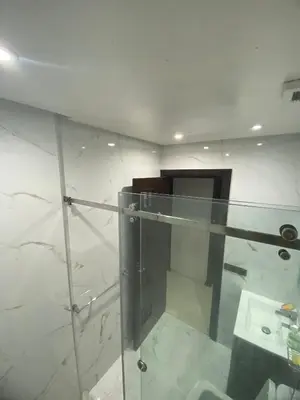 a bathroom with a sink and a glass wall at The White House in Casablanca
