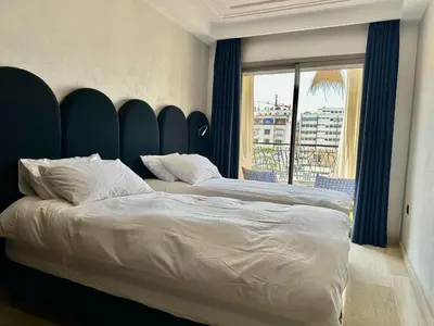 a bedroom with a large bed and a large window at Central Cosy 2BR 2 Baths, Balcony & Clear View in Casablanca